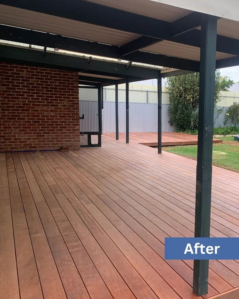 Finished timber deck under the pergola with the house beyond, same site after the build