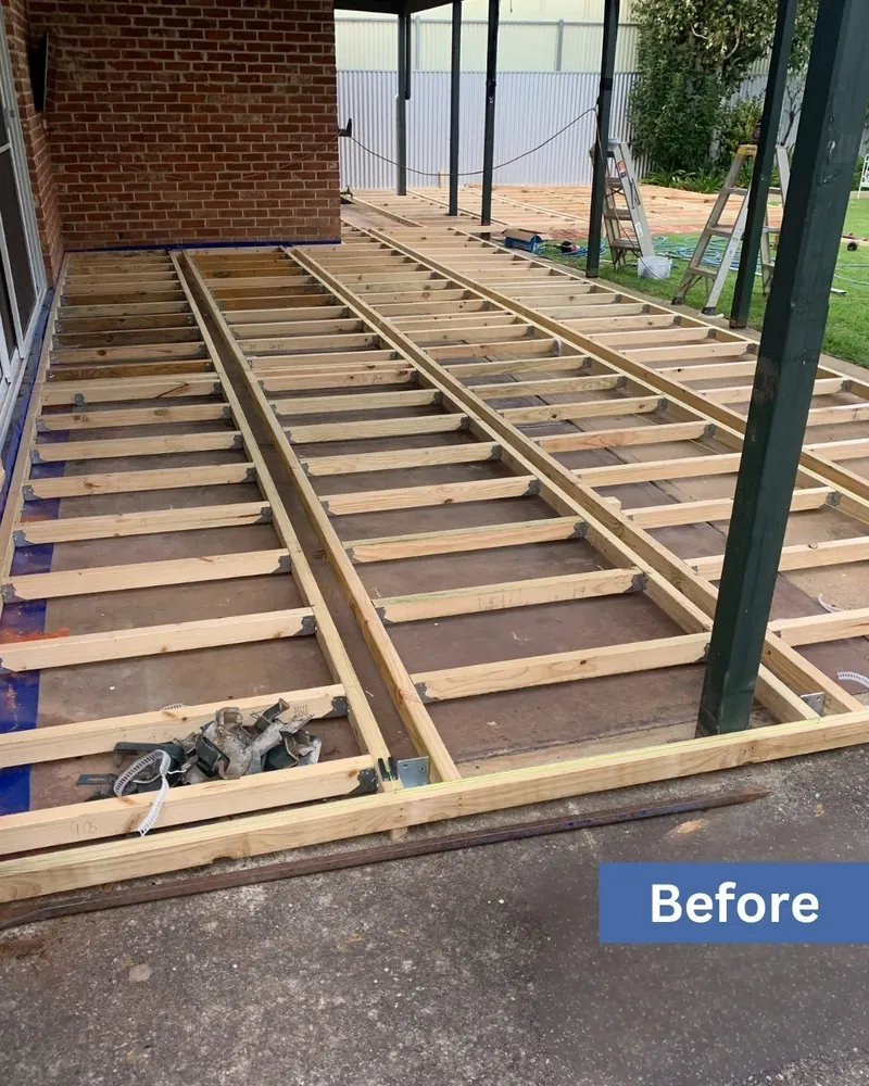 Bearers and joists of a new deck subfloor set out under a pergola frame