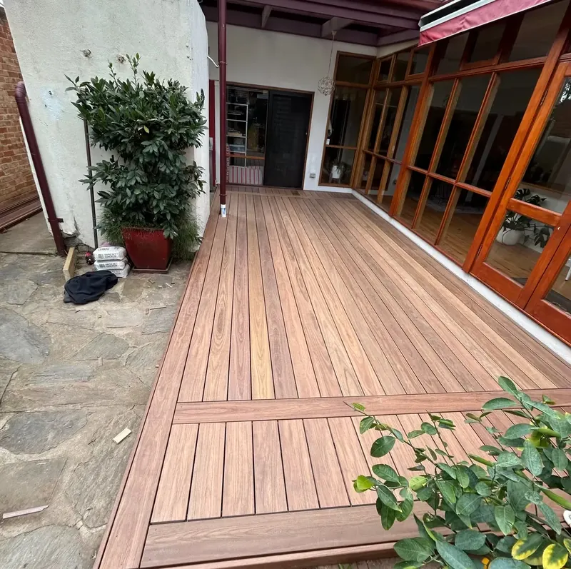 Custom timber deck wrapping a courtyard outdoor living area