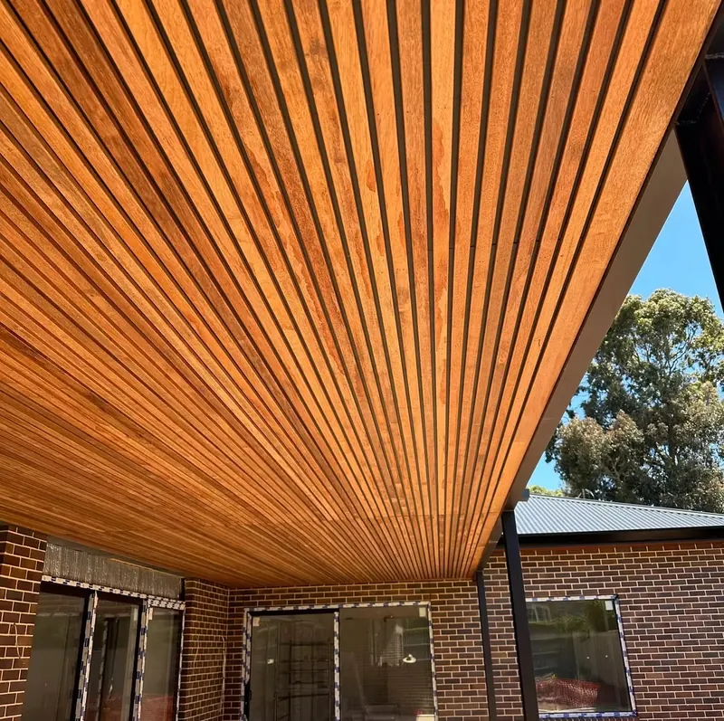 Timber-lined ceiling over an outdoor area, seen from below