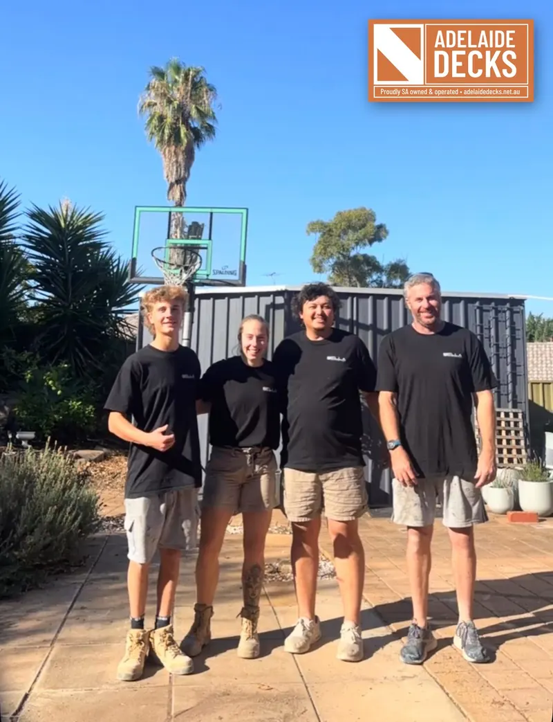 The Adelaide Decks team of four carpenters in their work shirts, with the Adelaide Decks logo