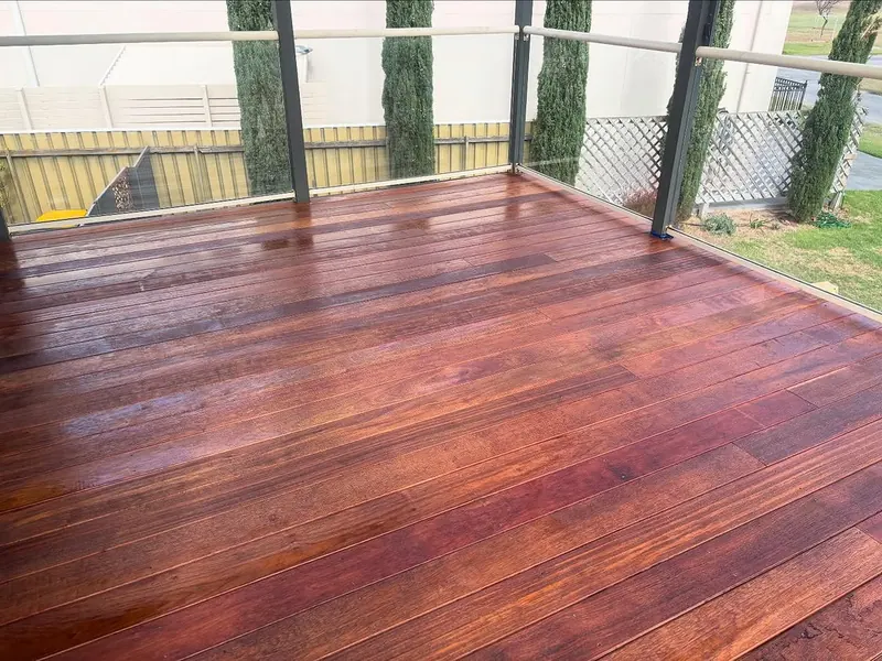 Rich red timber deck with glass balustrade built in an Adelaide backyard